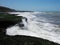 Strong waves breaking on the beach stone mountains