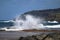 Strong waves hitting rocks at Leao beach in Noronha, Praia do Leao.
