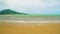 Strong waves on the seashore in cloudy weather, in front of a storm, beach sand, an island on the horizon