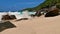 Strong waves smashing against granite rock formations with spray and foam on remote beach Anse Capucins, Mahe, Seychelles.