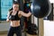 Strong woman in time of workout at boxer club