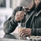 Strong young active man with beard wearing cap and sport hoodie drinking orange juice using straw for beverage healthy nutrition