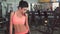 Strong young brunette woman posing in sport gym. Slow motion