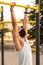 Strong young latin man doing calisthenics with mask