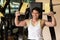 Strong young man exercising for arms muscles at a fitness club