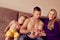 A strong young man sits with his children and wife at home on th