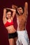 Strong young man and woman with dumbbells