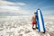 Strong young surf man portrait at the beach with a surfboard. Ba