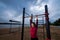 Strong Young woman goes sports outside. Lady pulling up in workout area.