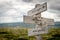 Stronger than yesterday text on wooden signpost outdoors in nature.