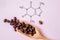 Structural chemical formula of caffeine molecule with roasted coffee beans. Caffeine is a central nervous system stimulant