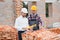 Structural engineer and foreman worker discuss, plan working for the outdoors building construction site