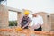 Structural engineer and foreman worker discuss, plan working for the outdoors building construction site