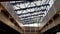 Structural glazing of the facade. Abstract background with glass ceiling elements in a modern building. view of the blue sky