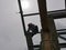 A structural steel worker working on a high rooftop for a house roof structure installation