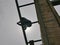 A structural steel worker working on a high rooftop for a house roof structure installation