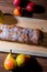 Strudel with apples, yellow pears, peaches on a wooden board,