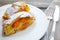 Strudel pumpkin and apple with raisins on parchment, fruit and vegetables on a dark wooden board