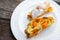 Strudel pumpkin and apple with raisins on parchment, fruit and vegetables on a dark wooden board