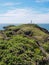 Strumble Head Lighthouse on Ynys Meicel with white clouds, Pembrokeshire, Wales