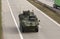 Stryker, wheeled armored vehicle drives on highway .