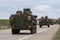 Strykers,wheeled armored vehicles drive on highway .