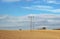 Stubble field with power line masts in autumn