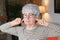 Stubborn senior woman blocking ears with fingers