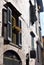 The stucco facade of a row of old town houses in the historic old town of Bergamo, Italy.
