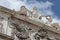 Stucco molding on the top part of a facade of the building against the sky with clouds in Lisbon, Portugal