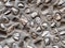 Stucco with pebbles closeup. Gray uneven cement covered with large pebbles