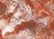 Stucco rusty red brown grey marble gem stone flooring pattern. Texture of Vintage Rust Red Speckled Faux Stone Acrylic
