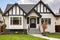 stucco and wood tudor home with a detailed front gable