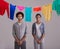 Stuck in the routine of life. Studio shot of a young couple standing in front of a washing line full of colorful laundry