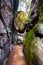 Stuck sandstone boulder above narrow pass