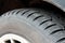 Studded car tire, snow tire. Car tire with spikes. Winter tire. Old automobile tire