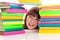 Student behind pile of books
