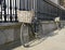 Student bicycles with baskets against a fence