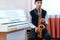 Student boy plays saxophone while sitting at a music lesson in class