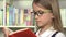 Student child reading books in library school girl studying learning in class 4K