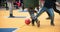 Student children play football with ball in the school yard