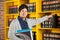 Student Choosing Book From Shelf In Library