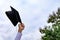 Student with congratulations, graduates wearing a graduation gown of university