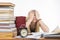 Student covering her eyes with her hands to take a break from their studies