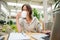 Student drinking coffee while using laptop at cafeteria table