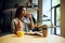 Student drinks coffee with croissants in cafe