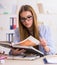 Student examining animal skeleton in classroom