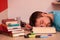 Student fallen asleep in the middle of a large book