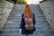 Student girl with a backpack climbing stairs