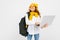 Student girl in casual clothes with a backpack with a laptop in hand on a white background
